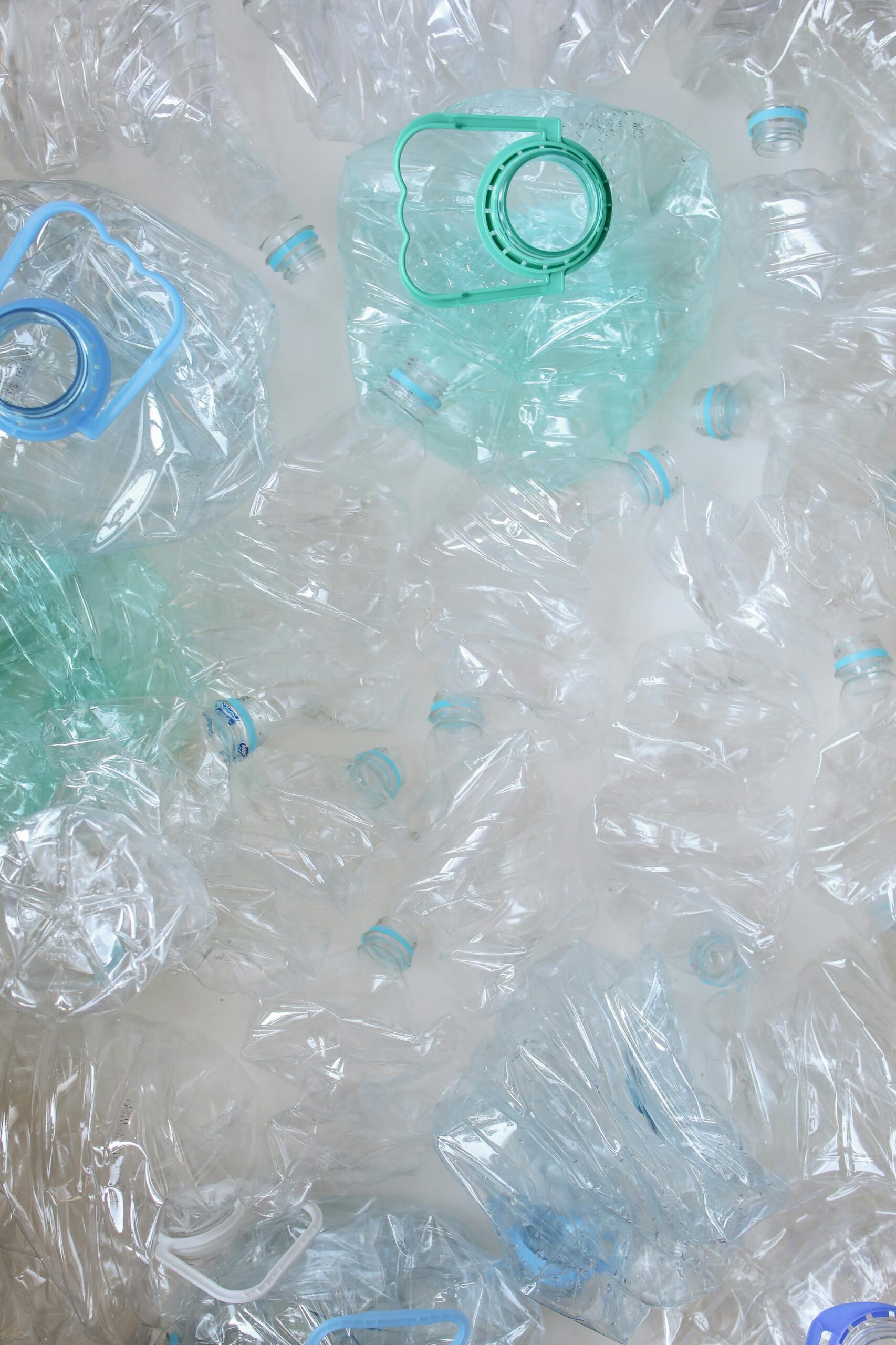 pexels-photo-3735215-3735215 Top view of crumpled plastic bottles, symbolizing recycling and sustainability.